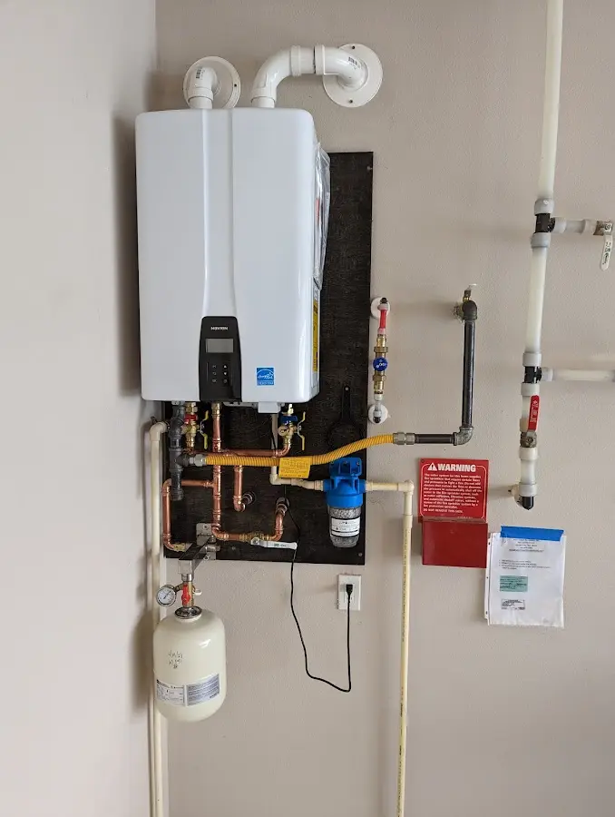 Professional plumber installing copper piping in a Wanaque home